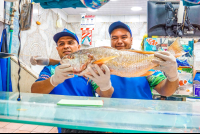        Vip City Tour Men Holding A Fish At Central Market
  - Costa Rica