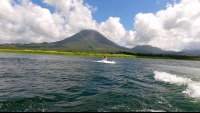 a man starting to wakeboard on lake arenal
 - Costa Rica
