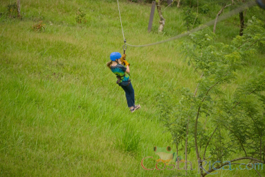 Young Girl Riding A Cable On Blue River Zipline Rincon De La Vieja
 - Costa Rica