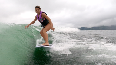 a young lady wakesurfs on lake arenal
 - Costa Rica