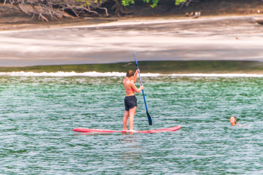 Lady Doing Stand Up Paddle In Playa Huevos Marlin Del Ray Catamaran
 - Costa Rica