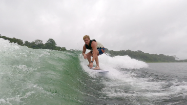 a man surfs the wake on lake arenal
 - Costa Rica