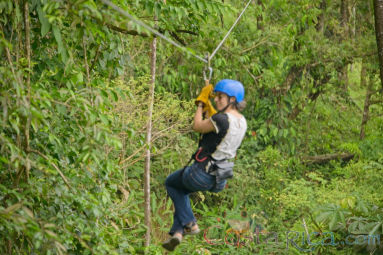 Woman Riding A Zip Line Cable Blue River Zipline Rincon De La Vieja
 - Costa Rica