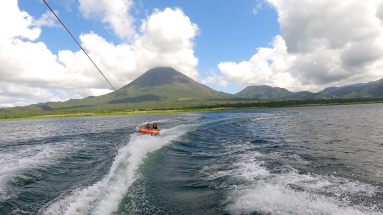 a couple of friends tubing on lake arenal with the view of the volcano
 - Costa Rica