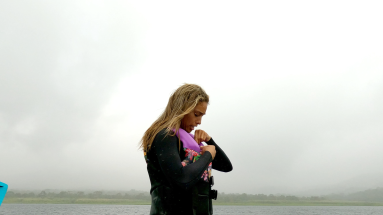 a lady secures her gear to start wakeboarding
 - Costa Rica
