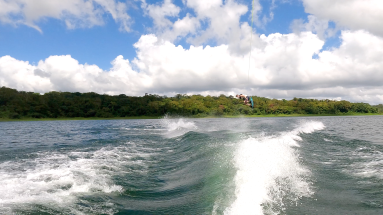a make jumping above lake arenal as he wakeboards
 - Costa Rica