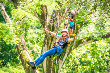 Young Lady Zip Linging From A Tree Platform Tizati Zip Line Rincon De La Vieja
 - Costa Rica