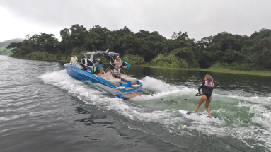 wakeboarding lesson on lake arenal an instructor tells a guest how to do it
 - Costa Rica
