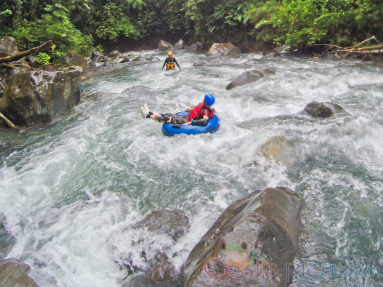 Lady Tubing On The Rocky Rapids Of Blue River Rincon De La Vieja
 - Costa Rica