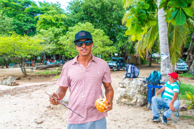 Guide At The Beach Checking In People For The Catamaran Tour
 - Costa Rica