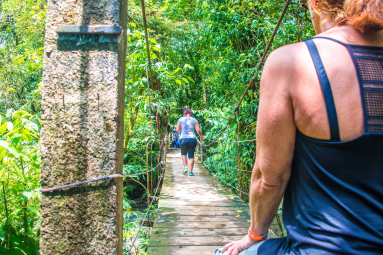 People Crossing The Celeste River Hanging Bridge
 - Costa Rica