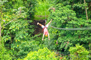 A Man Zip Lining Upside Down Los Canones Canopy Tour La Fortuna
 - Costa Rica