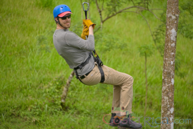 Man Riding A Cable On Blue River Zipline Rincon De La Vieja
 - Costa Rica