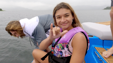 lady smiles to the camera as she prepares for jumping in the lake
 - Costa Rica